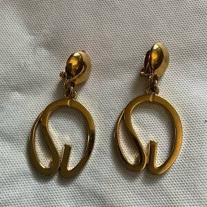 Large St John gold toned dangle clip-on logo earrings